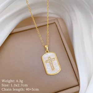 Detailed gold necklace specifications showing cross shell pendant on a silk background