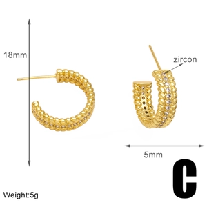 Detail of twisted gold C-shape hoop earrings with zircon stones and 18mm diameter measurement