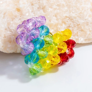 Rainbow faceted crystal bead charm on stone background for handmade jewelry