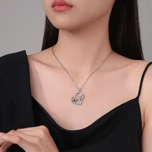 Silver heart necklace featuring a girl and dog pendant with rose gold details