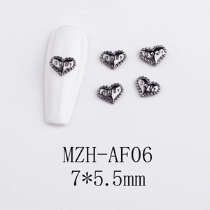 Detailed view of gunblack heart nail charms with BABY engraving and beaded edges