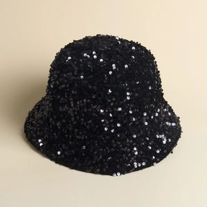 Close-up of a black sequined bucket hat showing shimmering texture on a neutral background