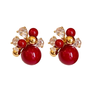 Elegant gold plated floral earrings with red pearls and sparkling zircon accents