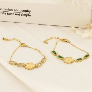 Detail of gold flower bracelets with emerald and white zircon rectangular settings