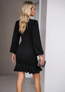 Rear view of a black slim fit dress featuring puff sleeves and ruffled hemline detail