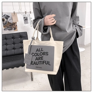 Detail of the minimalist canvas tote bag with 'All Colors Are Beautiful' graphic print
