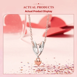 Detail showing S925 silver double rings engraved with Family and rose gold heart charm