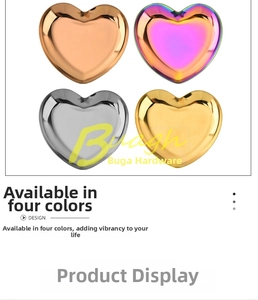 Detail of four-color heart-shaped stainless steel trays with a mirror polished finish
