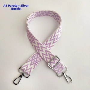 Detailed macro view of wide woven purple wave pattern bag strap with silver metal buckle
