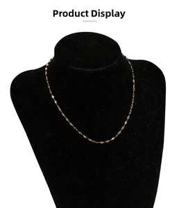Detail of 18k gold plated stainless steel lip chain necklace on black velvet mannequin