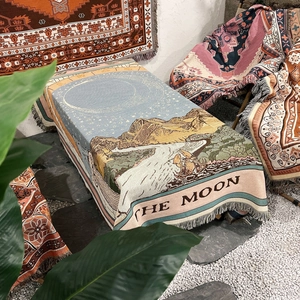 Detail of bohemian cotton blanket with The Moon tarot design and fringe tassels