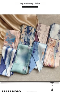 Detailed flat lay of vintage silk scarves with traditional Chinese crane and landscape prints