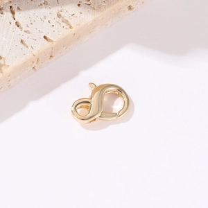 Detailed macro view of 14k gold-plated heart lobster clasps for DIY jewelry making