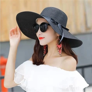 Foldable black wide-brim straw sun hat with matching ribbon bow for summer beach travel