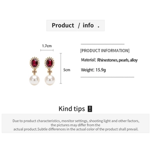 Detailed view of vintage pearl drop earrings with red oval rhinestone and dimensions