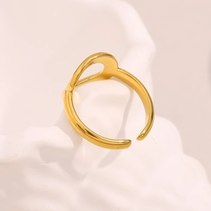 Dettaglio dell'anello geometrico placcato in oro 18 carati su superficie in ceramica