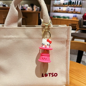 Cute Hello Kitty LED night light keychain hanging on a canvas bag for decoration