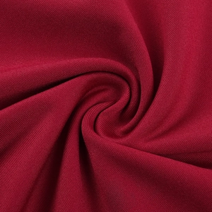 Detailed macro view of dark red knit fabric with soft texture and elegant drape