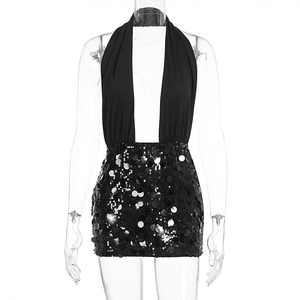 Detail of black sequined mini dress featuring halter neck design and shiny silver sequins