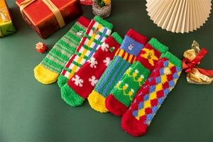 Close-up of six pairs of warm coral fleece Christmas socks in various festive patterns