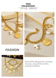 Detail of vintage gold stainless steel cross and religious emblem pendant jewelry set