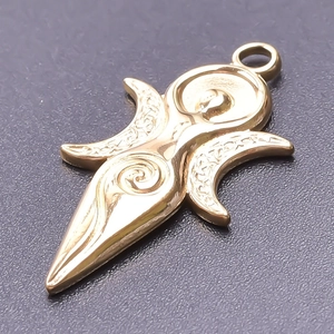 Macro detail of a 18k gold-plated sun and moon pendant with Celtic knots and crescent moon