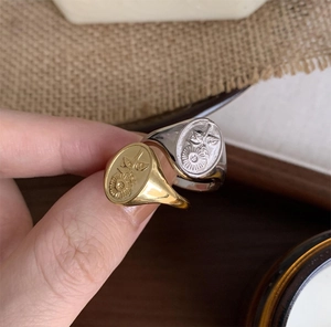 Detailed close-up of vintage gold and silver sunflower signet rings for women