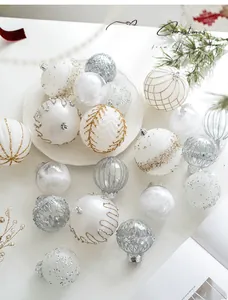 Detail of champagne and silver Christmas balls with glitter textures and feather filling
