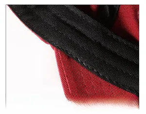 Macro detail of the thickened black inner sweatband with fine stitching on a red cap
