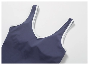 Detail of V-neck yoga top with contrast white piping and high-elastic purple fabric