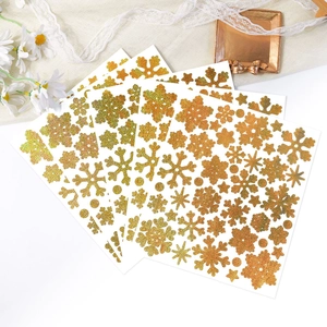 Detailed view of golden glitter snowflake stickers on a rustic lace and woven background