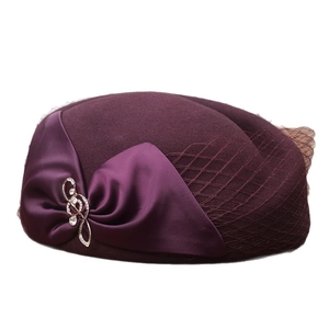 Elegant dark purple wool beret hat with satin bow, musical note brooch, and mesh veil