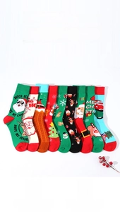 Flat lay of Christmas theme cotton mid-calf socks with Santa and reindeer patterns