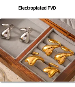 Detailed view of PVD electroplated gold and silver heart rings in a velvet jewelry box