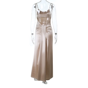 Detail view of champagne gold satin dress featuring an elegant backless design and ruching
