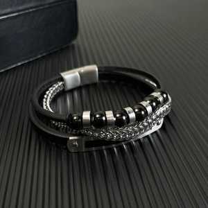 Men's multilayer black leather bracelet with silver chain and magnetic clasp on dark surface
