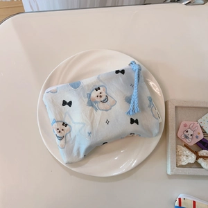 Close-up of blue cotton mini pouch with cute cartoon dog and baby heart patterns