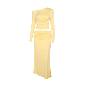 Elegant pale yellow two-piece set featuring off-shoulder long sleeve top and midi skirt