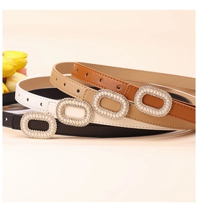 Detailed view of women's leather belts with pearl and rhinestone oval buckles in three colors