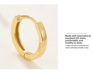 Macro detail of the S925 hallmark on a minimalist gold-plated silver hoop earring