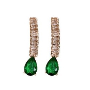 Elegant gold drop earrings with diamonds and green pear-cut gemstones on white background