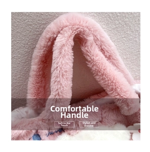Detailed close-up of the plush pink faux fur handle and blue floral embroidery on the bag