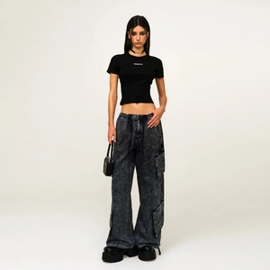 Vintage cargo pants with snow wash and black crop top set on a full-length model view
