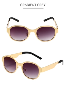 Vue détaillée de lunettes de soleil ovales en métal avec verres gris dégradés