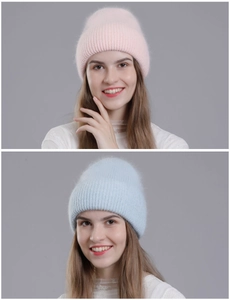 Close-up of soft pink and light blue rabbit fur knit hats showing plush texture on models