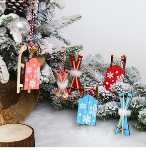 Close-up of rustic wooden sled and ski ornaments with snowflakes on snowy pine branches