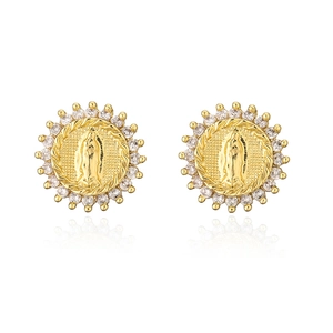 Close-up of 18K gold earrings with Virgin Mary relief and sparkling zirconia halo