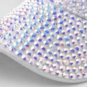 Macro detail of high-quality iridescent AB rhinestones on a white fabric sun visor hat