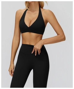Detail of black halter yoga bra and high waist leggings in soft brushed fabric