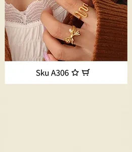 Close-up of gold-plated rose and wave design rings set against vintage lace background